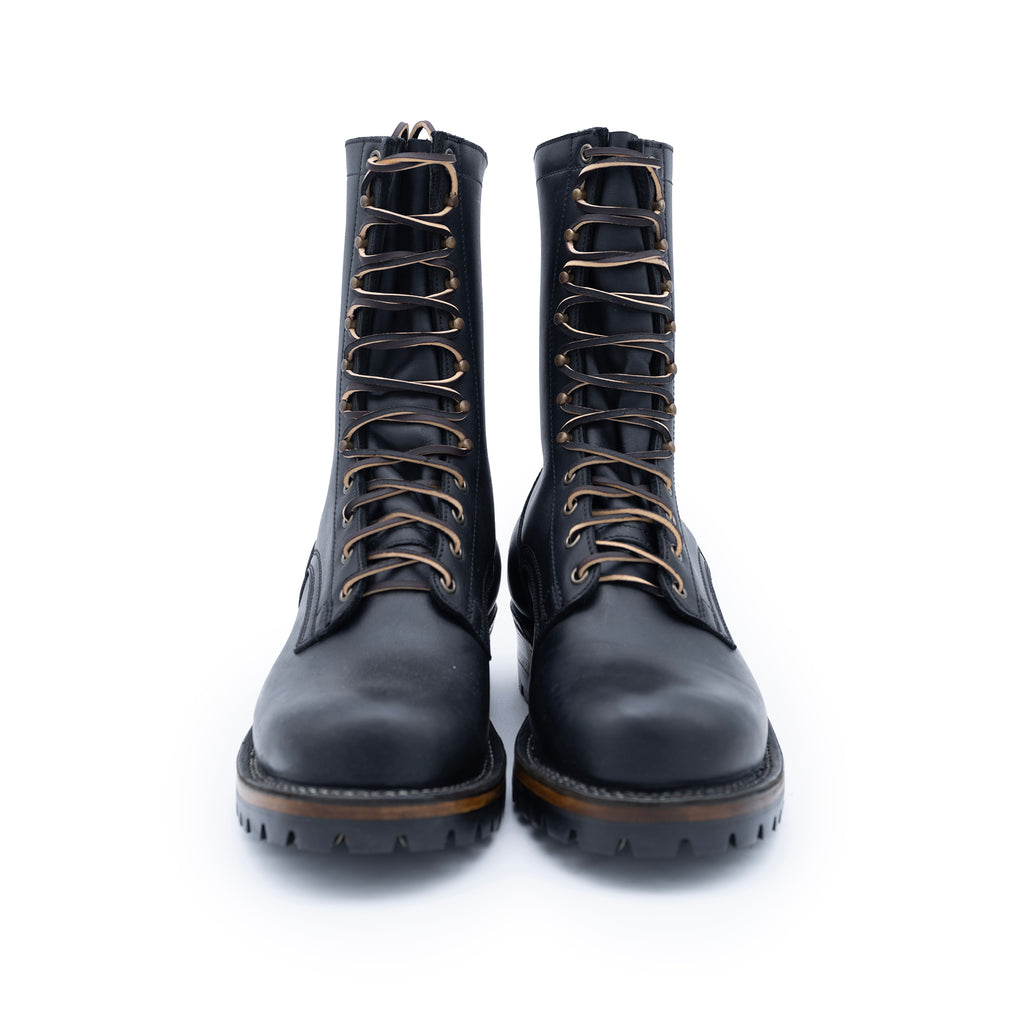 Pair of black leather boots with laces on a white background