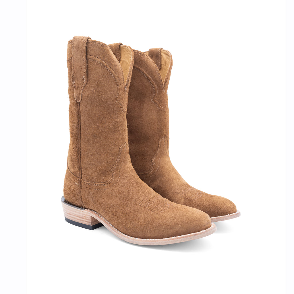 Pair of brown suede cowboy boots on a white background