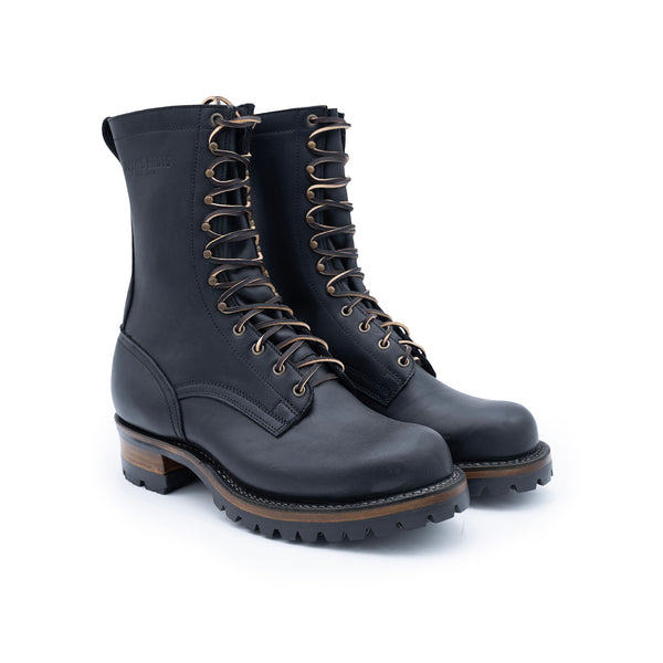 Pair of black leather boots with brown laces on a white background