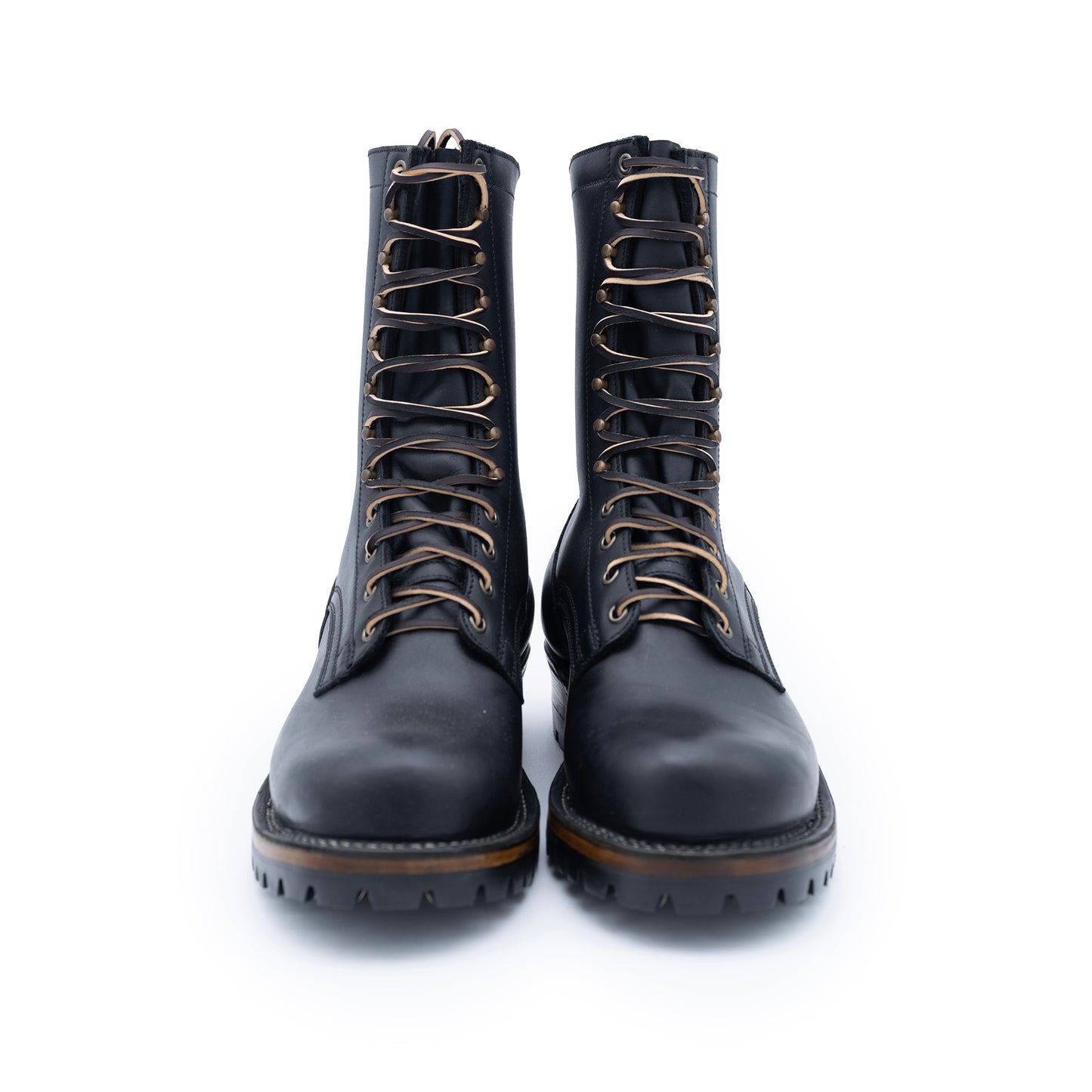 Pair of black leather boots with laces on a white background