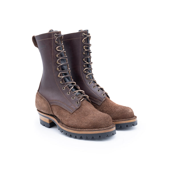 Pair of brown leather boots with laces on a white background