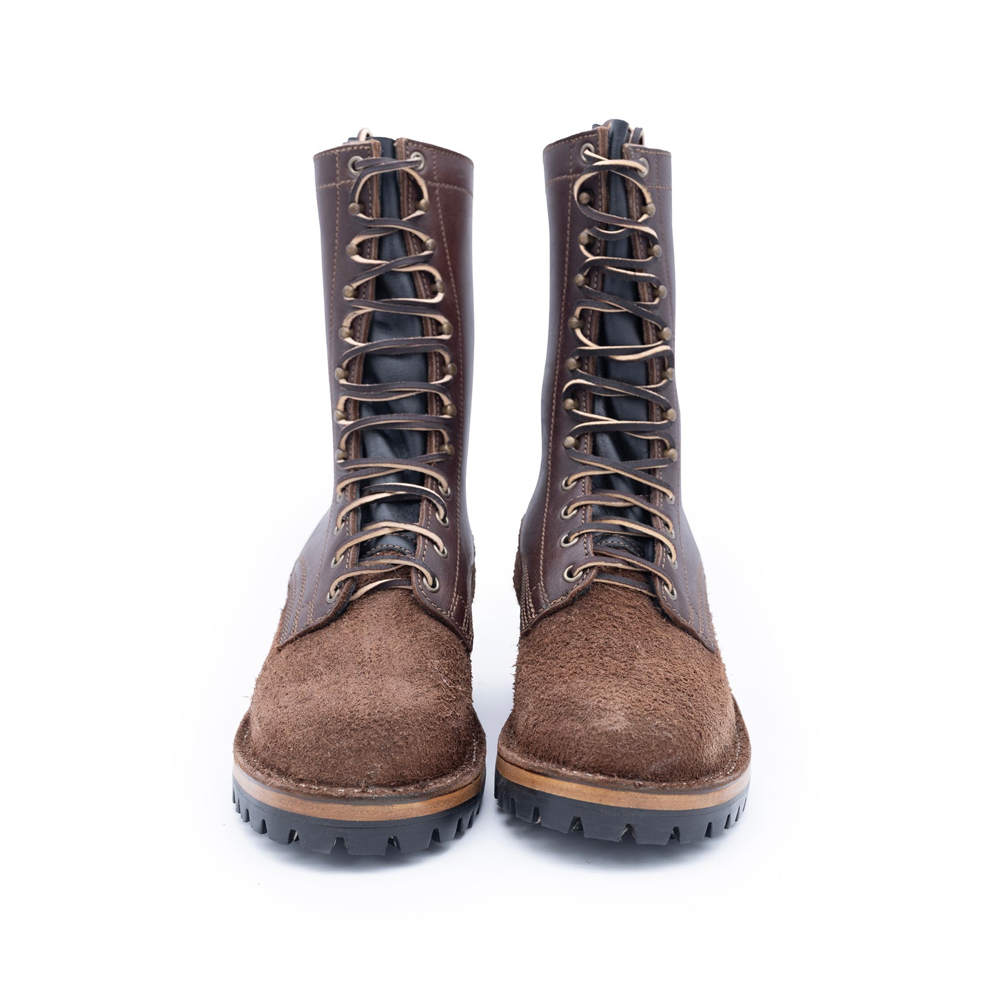 Pair of brown lace-up boots on a white background