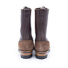 Pair of brown rubber boots with suede soles on a white background