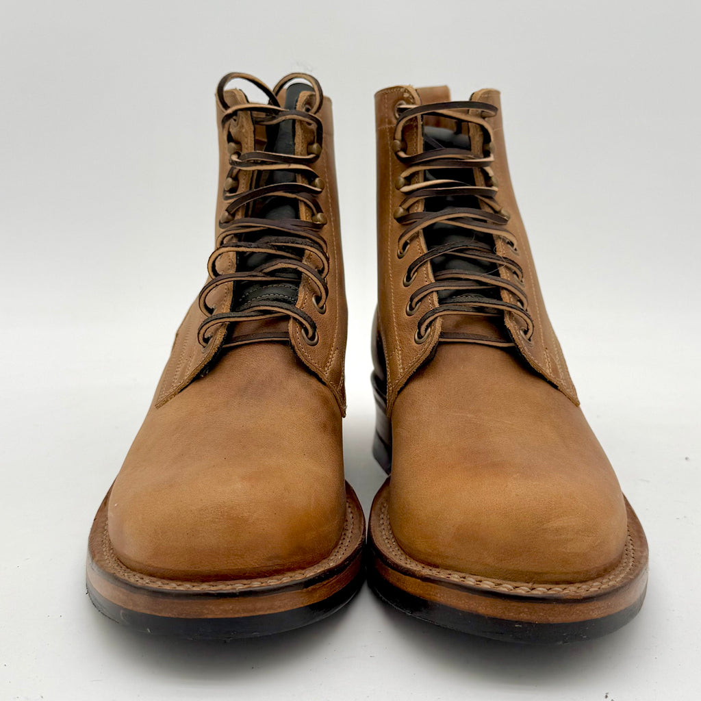 Pair of brown leather boots on a white background