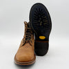 Brown leather boot with black sole on a white background