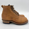 Brown leather boots with black laces on a white background