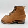 Brown leather boots with black soles on a white background