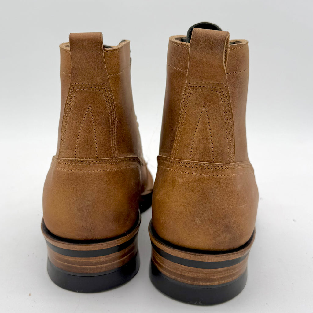 Pair of brown leather boots on a white background
