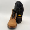 Brown leather boot with black sole on a white background