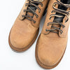 Pair of brown leather boots with laces on a white background