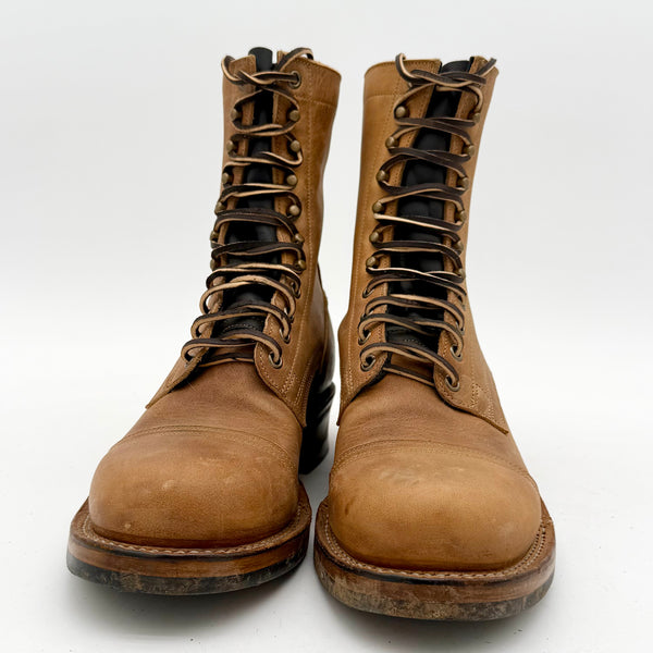 Pair of brown leather boots with laces on a white background