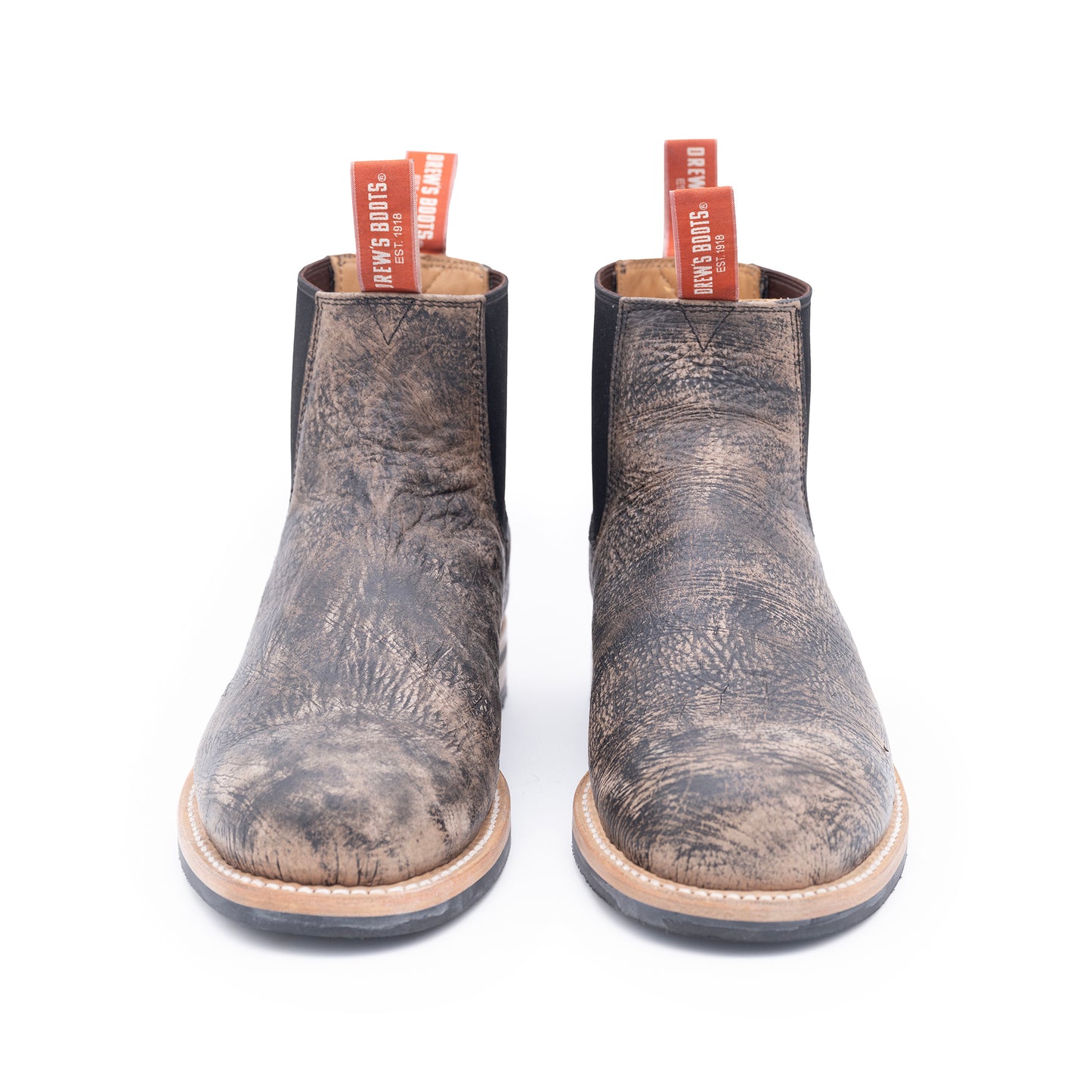 Pair of distressed brown boots on a white background