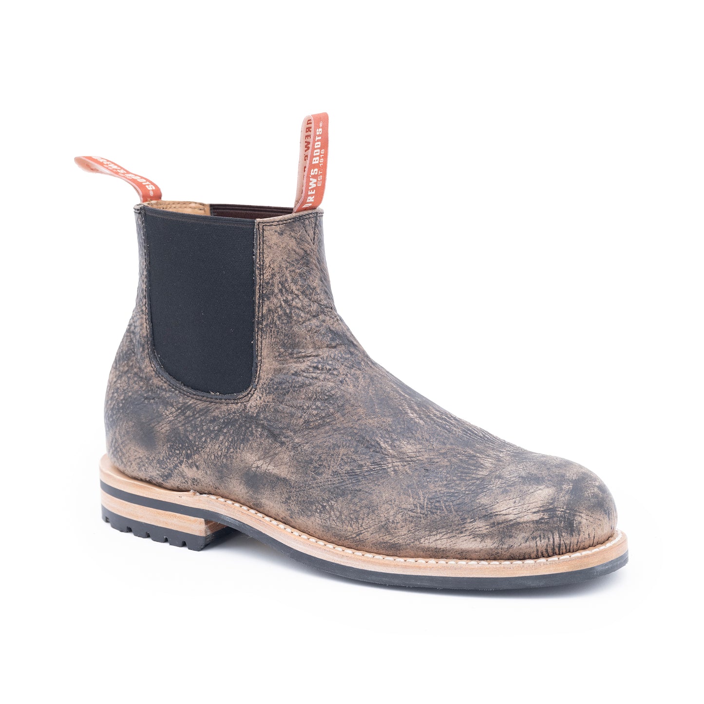 Worn leather Chelsea boot on a white background