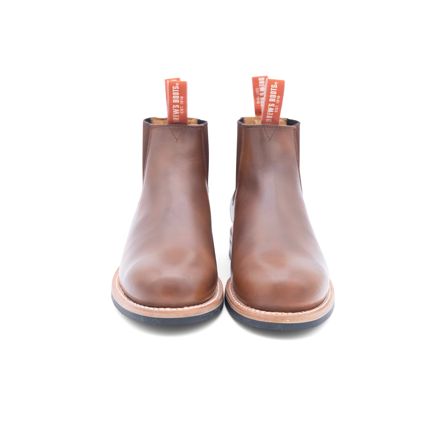 Pair of brown leather slip on chelsea boots on a white background