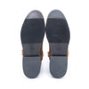 Pair of brown shoes with black soles on a white background