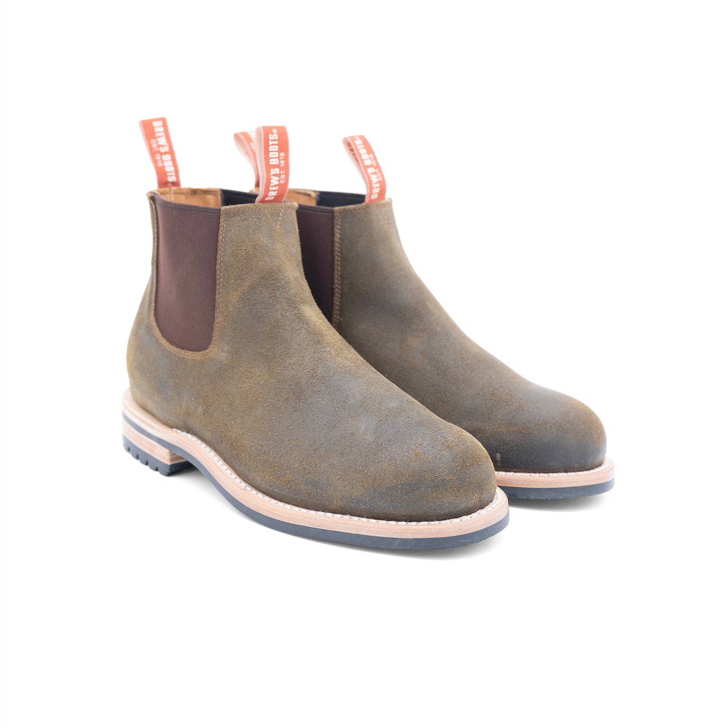 Pair of dark olive Chelsea boots with brown accents on a white background