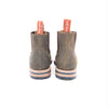 Pair of brown boots with visible brand name on a white background