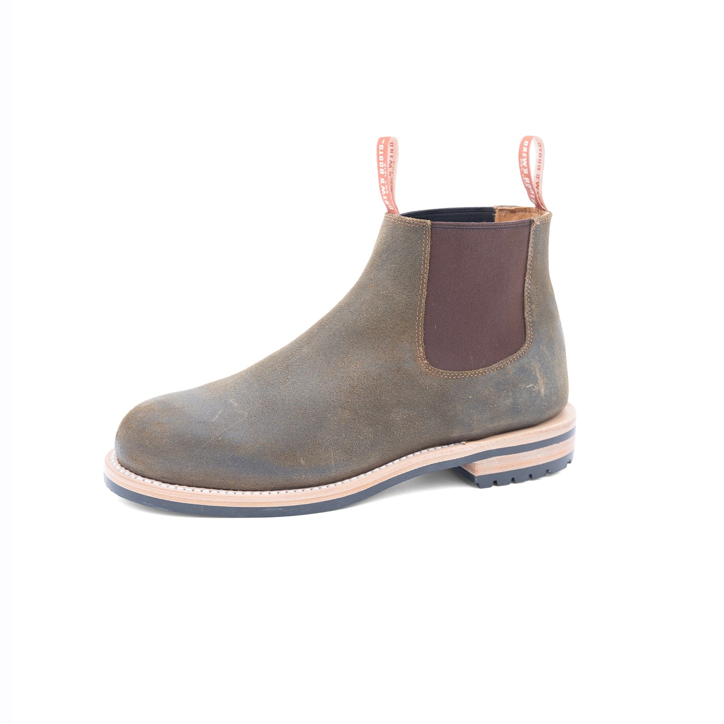 Olive Chelsea boot with brown patch on a white background