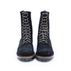 Pair of black suede boots with brown laces on a white background