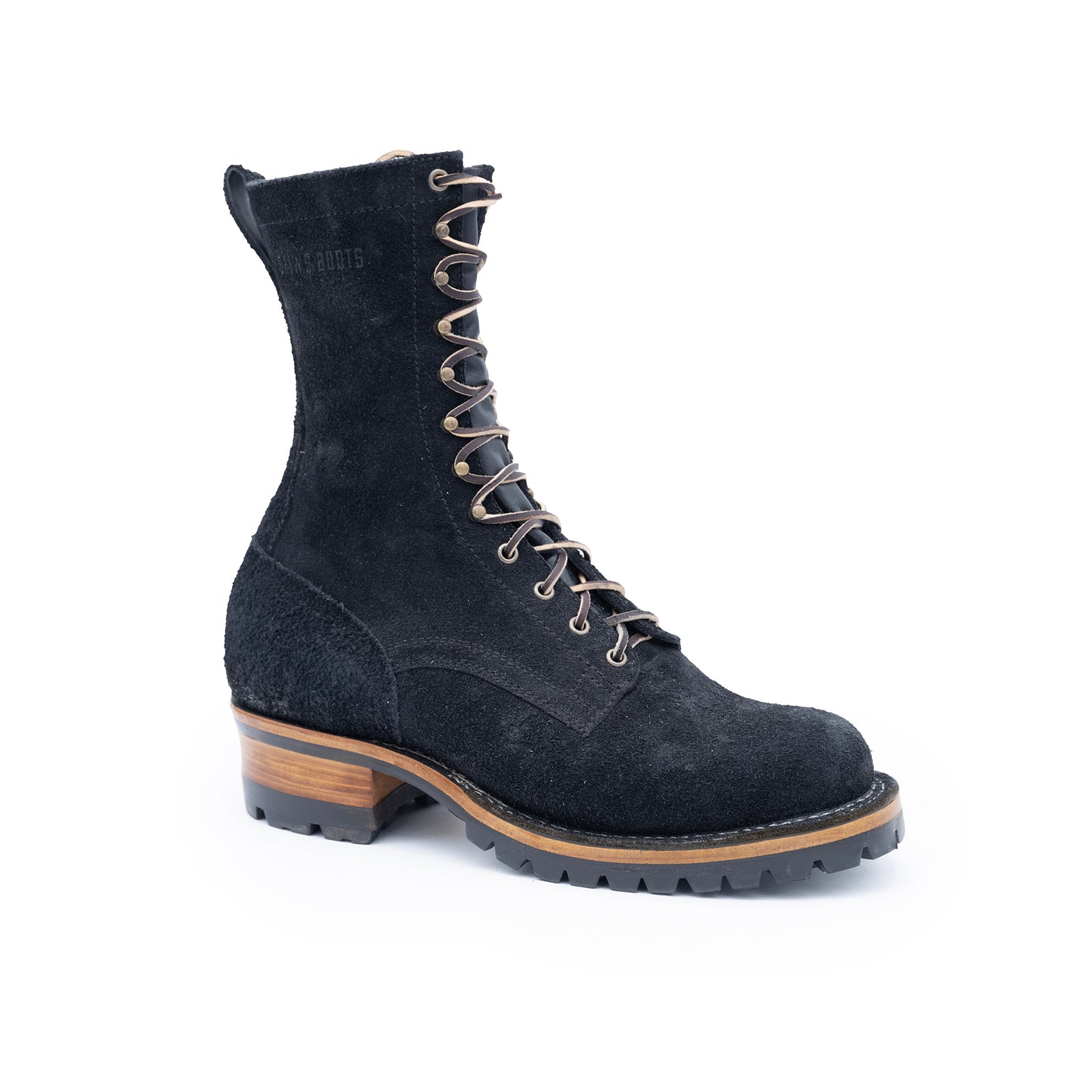 Black suede boot with brown sole on a white background