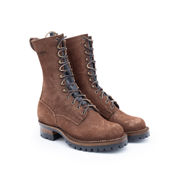 Pair of brown suede boots with black soles on a white background