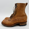 Brown leather boot with visible wear on a white background