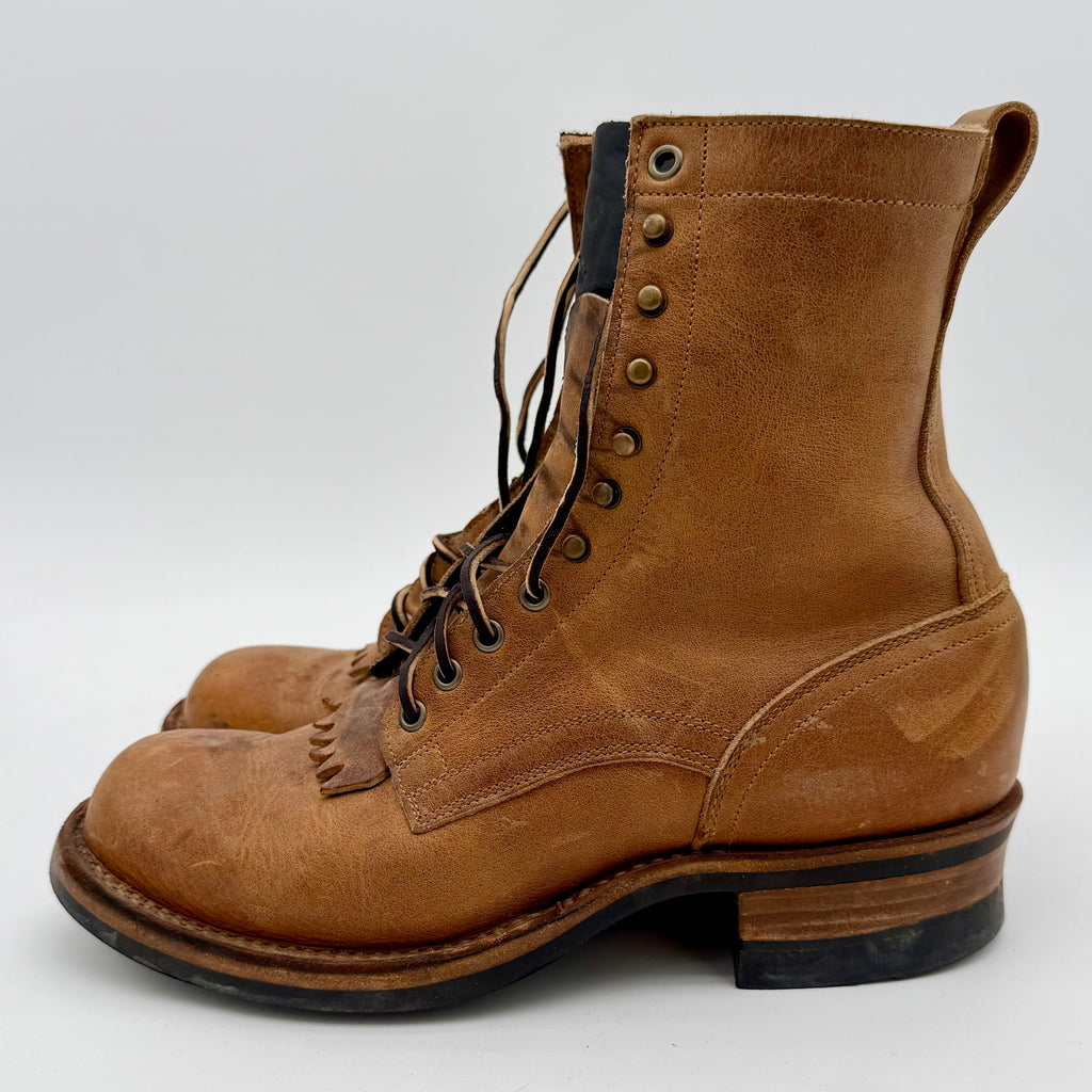Brown leather boot with visible wear on a white background