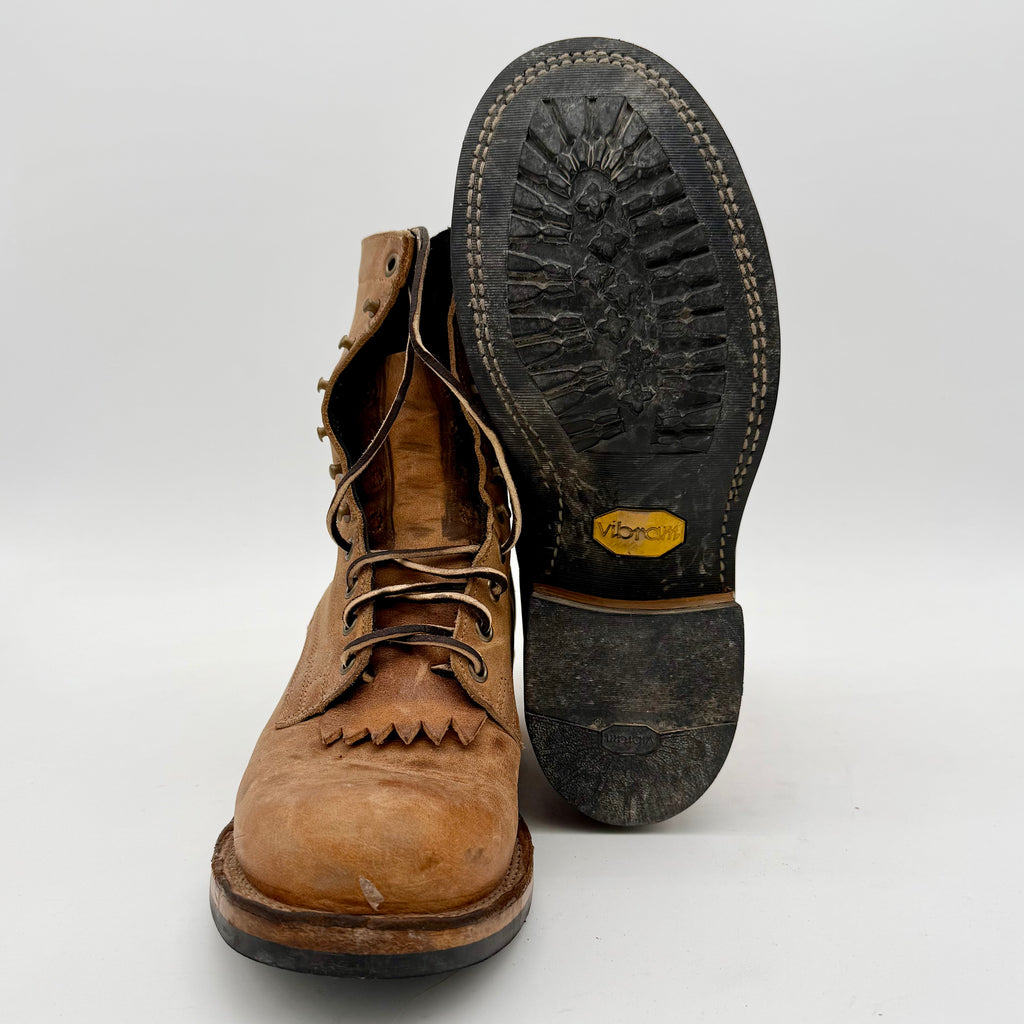 Brown leather boot with black Vibram sole on a white background
